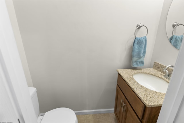 bathroom featuring tile patterned floors, vanity, and toilet