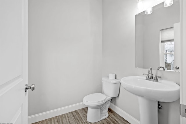 bathroom with hardwood / wood-style flooring, sink, and toilet