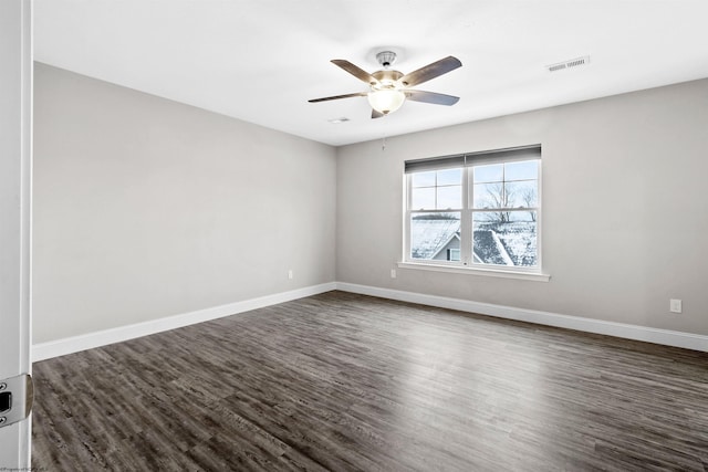 empty room with ceiling fan and dark wood-type flooring