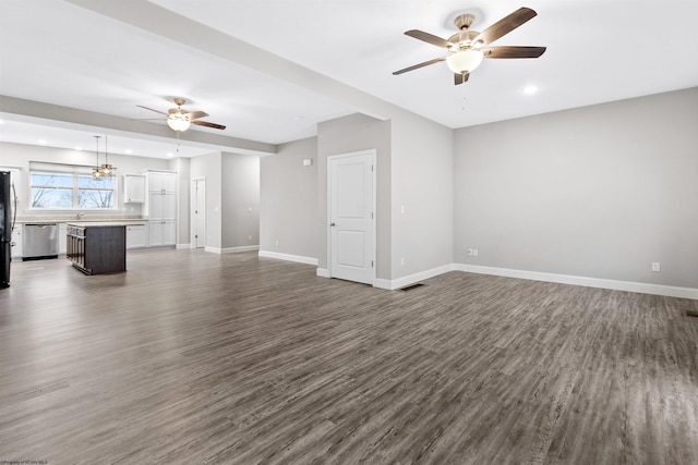 unfurnished living room featuring dark hardwood / wood-style floors and ceiling fan