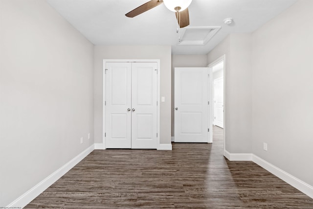 unfurnished bedroom with ceiling fan, dark hardwood / wood-style flooring, and a closet