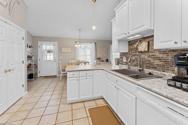 kitchen featuring white cabinets, white dishwasher, sink, hanging light fixtures, and kitchen peninsula