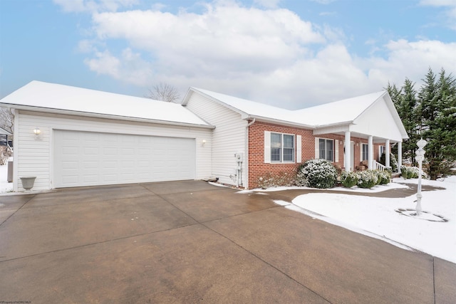 single story home with a porch and a garage