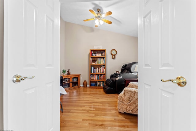 living area featuring hardwood / wood-style floors and ceiling fan