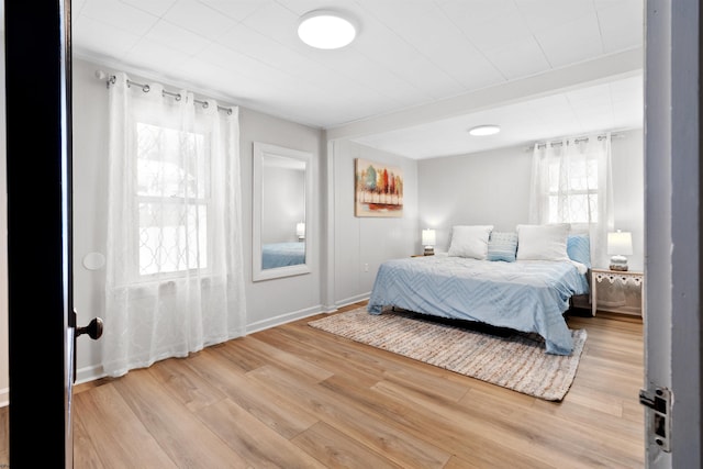 bedroom featuring hardwood / wood-style flooring and multiple windows