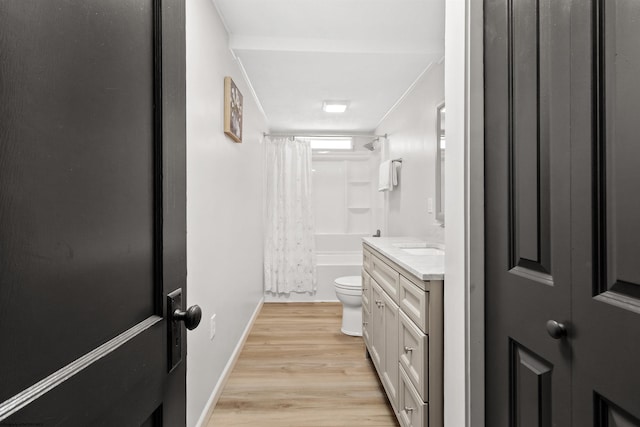 full bathroom featuring shower / bath combo, vanity, hardwood / wood-style flooring, and toilet