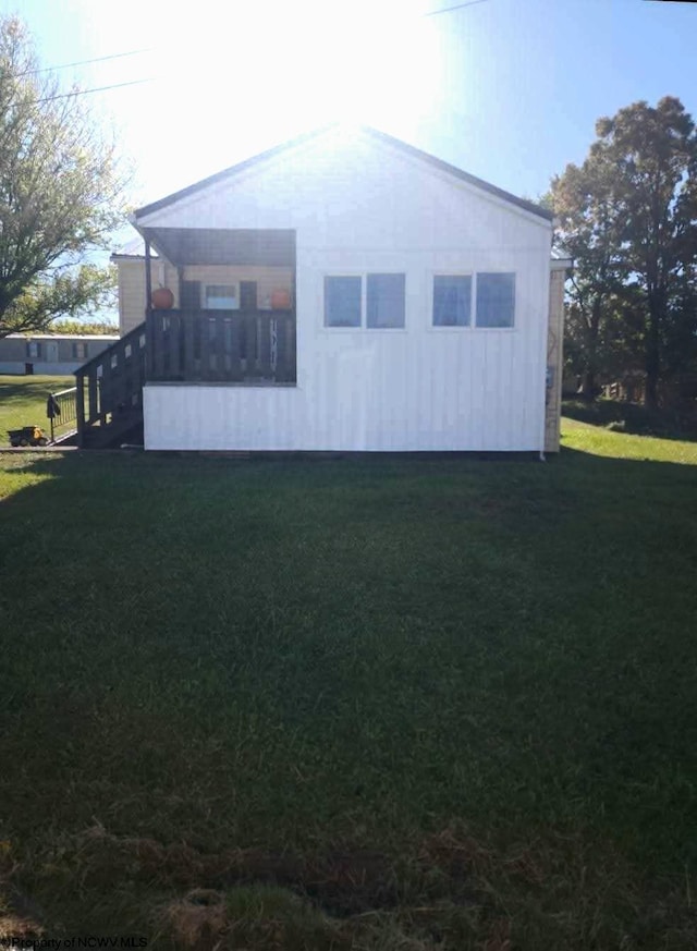 view of side of property with a yard