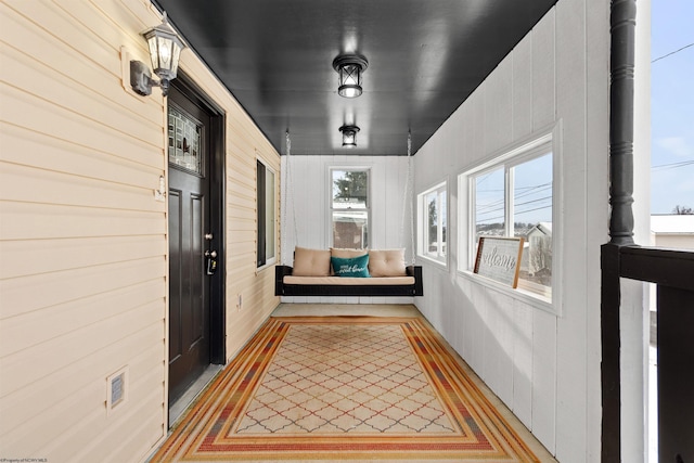 interior space featuring wooden walls and a healthy amount of sunlight