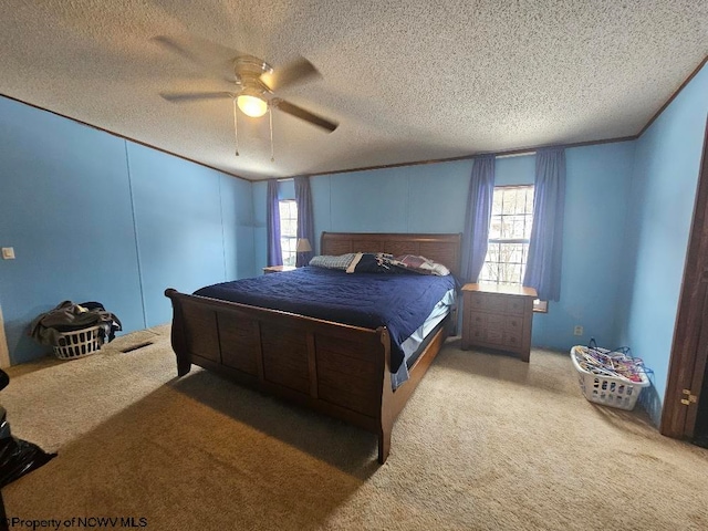 bedroom featuring light carpet, a textured ceiling, and ceiling fan