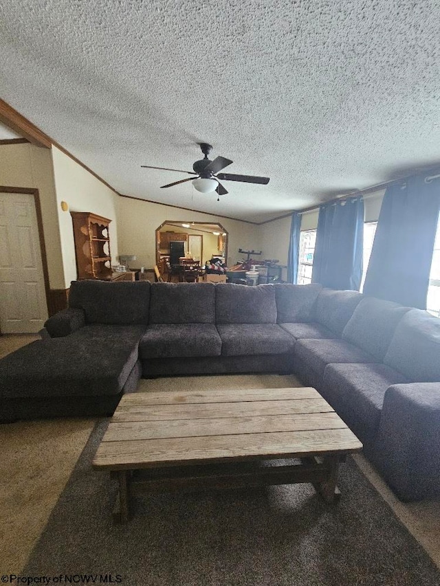 living room featuring a textured ceiling, vaulted ceiling, and ceiling fan