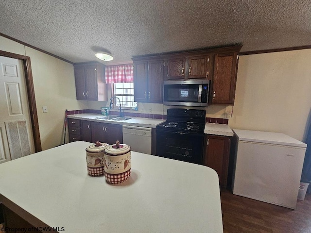 kitchen featuring white dishwasher, refrigerator, sink, electric range, and dark hardwood / wood-style flooring