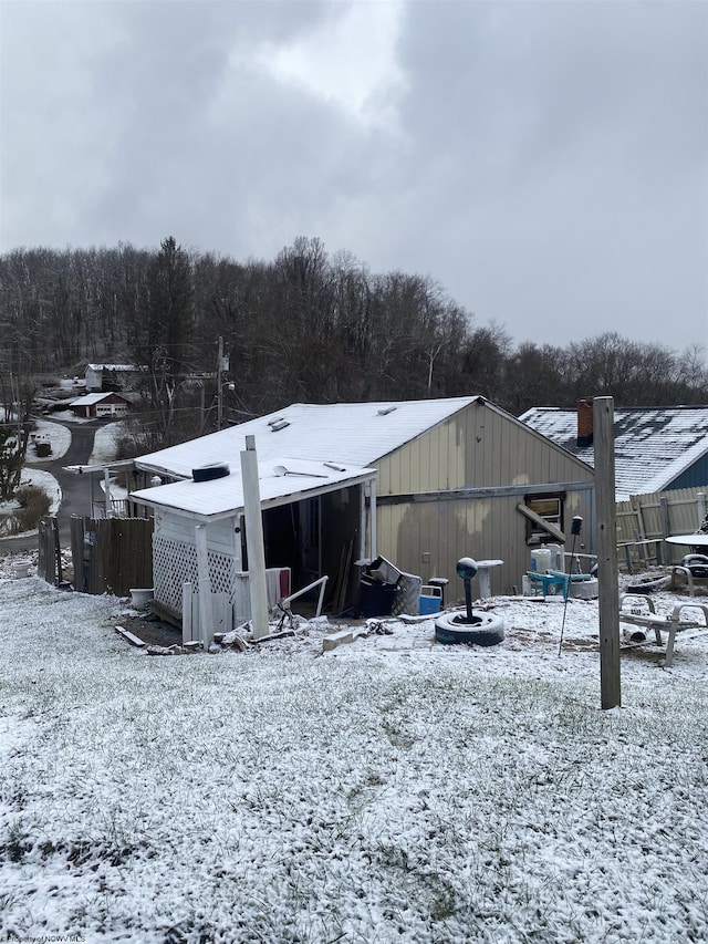 view of snow covered rear of property