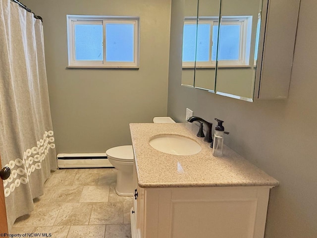 bathroom with vanity, toilet, and a baseboard heating unit