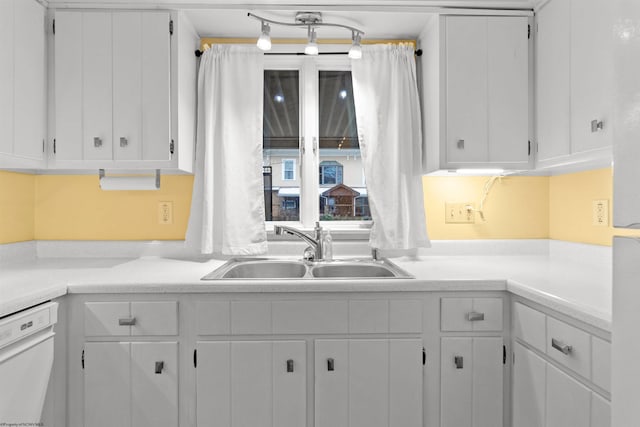 kitchen with white cabinets, dishwasher, and sink