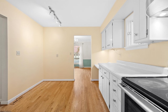 kitchen featuring white cabinetry, extractor fan, stainless steel range with electric stovetop, and light hardwood / wood-style floors