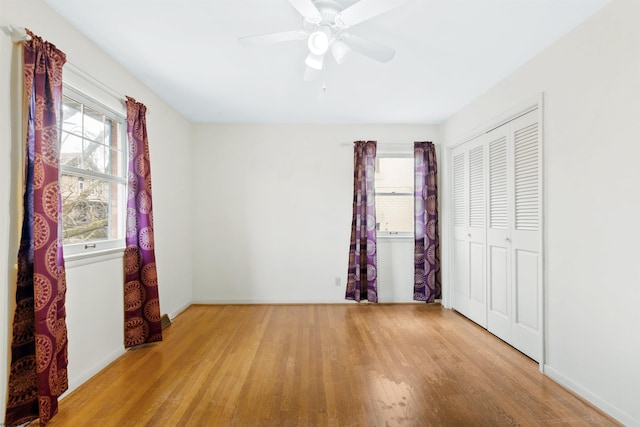 unfurnished bedroom with ceiling fan, a closet, and light hardwood / wood-style floors