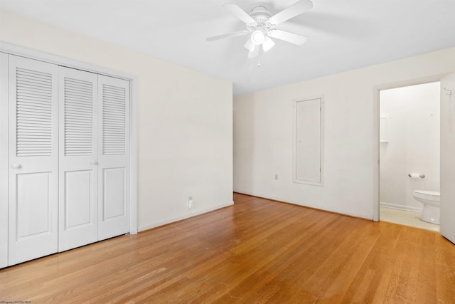 unfurnished bedroom featuring connected bathroom, light hardwood / wood-style floors, and ceiling fan