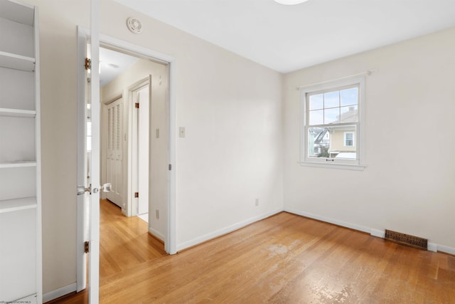 unfurnished room with hardwood / wood-style floors