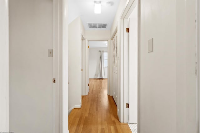 corridor with light wood-type flooring