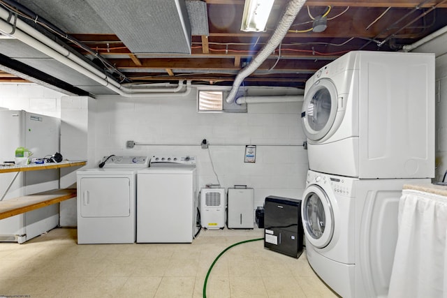 laundry area featuring stacked washer / drying machine