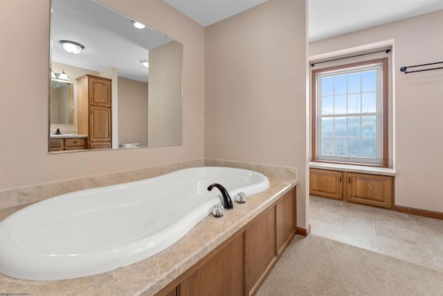 bathroom with tile patterned flooring and a tub to relax in