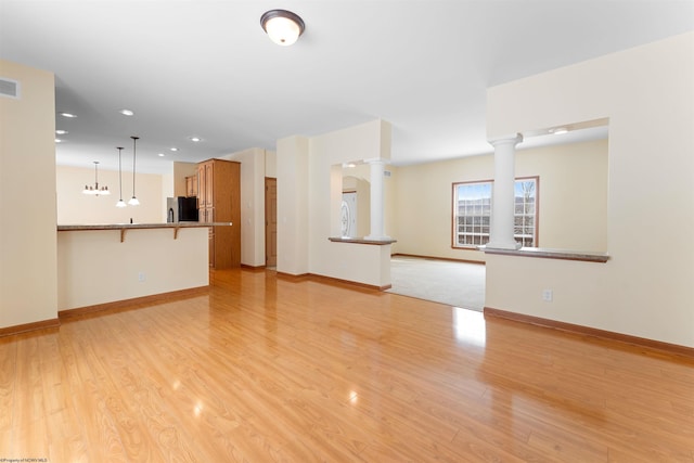 unfurnished living room with light wood-type flooring