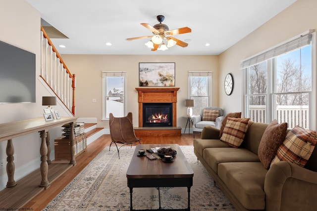 living room with ceiling fan and light wood-type flooring