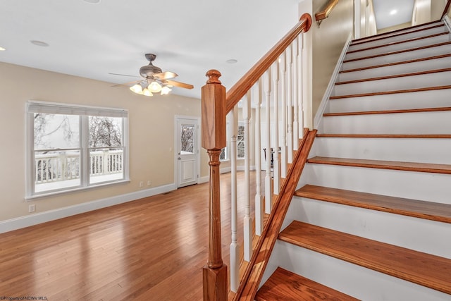 stairway with ceiling fan and hardwood / wood-style floors