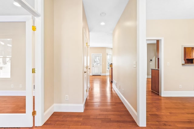 hallway with hardwood / wood-style floors