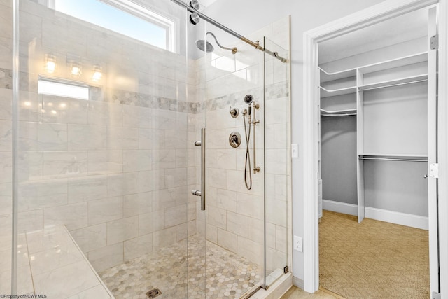 bathroom with a shower with door