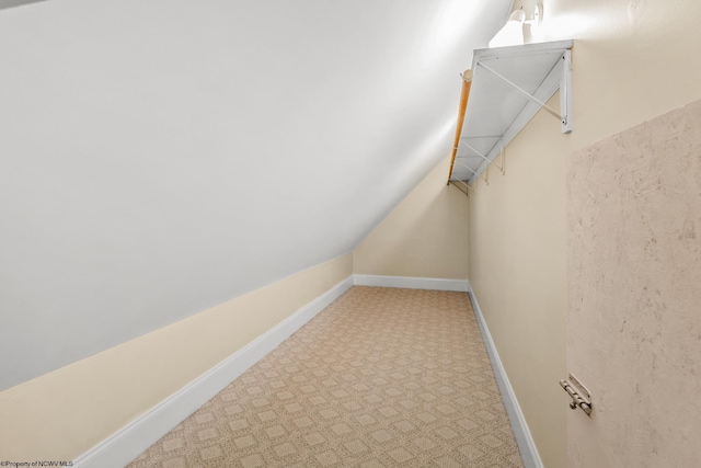 walk in closet featuring lofted ceiling