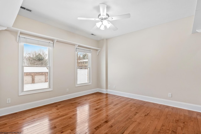 spare room featuring hardwood / wood-style floors and ceiling fan