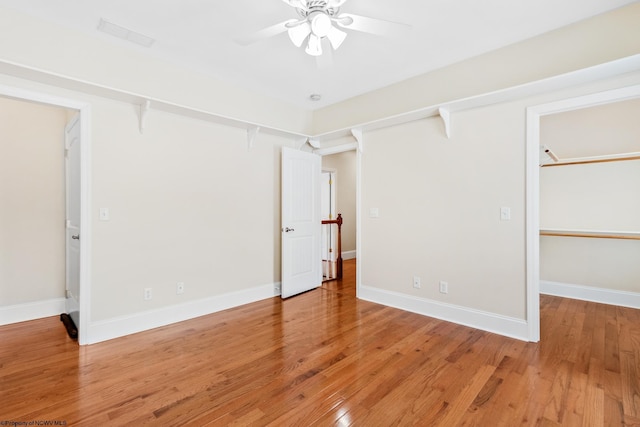 empty room featuring hardwood / wood-style flooring and ceiling fan