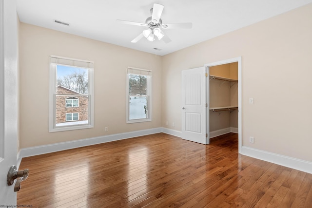 empty room featuring wood-type flooring and ceiling fan