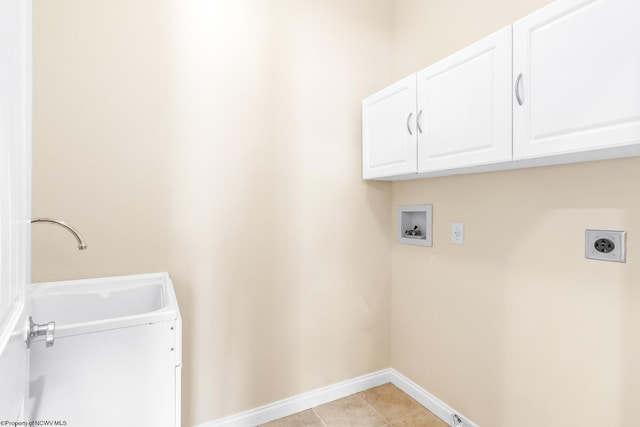 washroom featuring sink, cabinets, light tile patterned floors, hookup for a washing machine, and hookup for an electric dryer