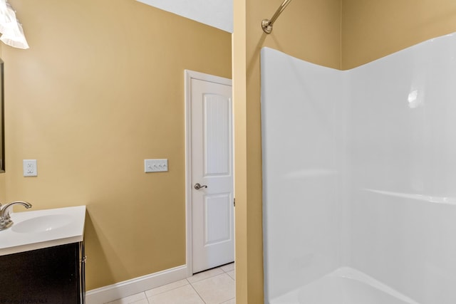 bathroom featuring vanity, tile patterned floors, and washtub / shower combination