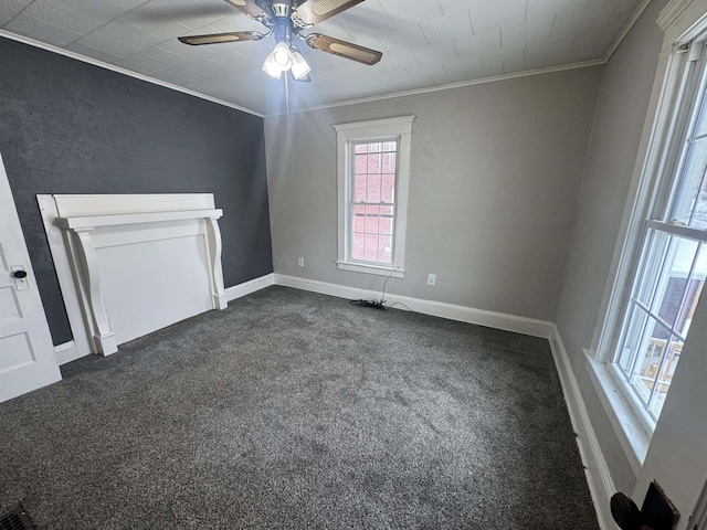 unfurnished living room with ceiling fan, ornamental molding, and dark colored carpet