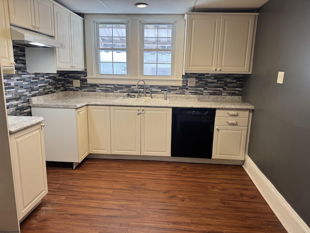 kitchen featuring white cabinets, light stone counters, sink, dishwasher, and dark hardwood / wood-style floors