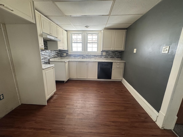 kitchen with dark wood-type flooring, dishwasher, a drop ceiling, and sink