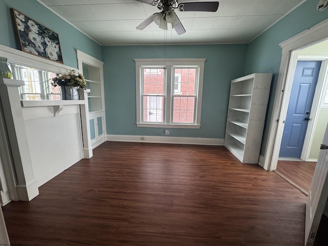 unfurnished dining area with dark hardwood / wood-style floors, ceiling fan, and built in features