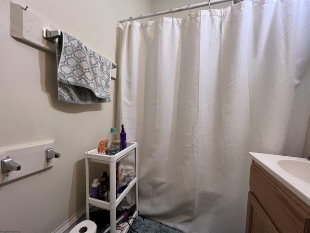 bathroom with curtained shower and vanity