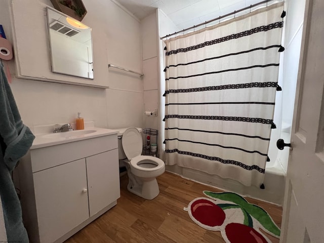 full bathroom with hardwood / wood-style floors, vanity, toilet, and shower / bath combo