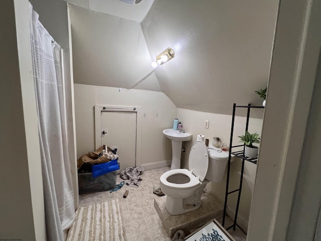 bathroom with sink, vaulted ceiling, and toilet