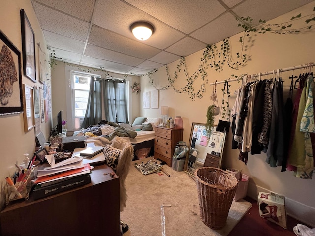 interior space with carpet floors and a drop ceiling