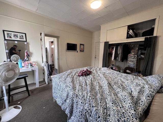 carpeted bedroom featuring a closet and crown molding