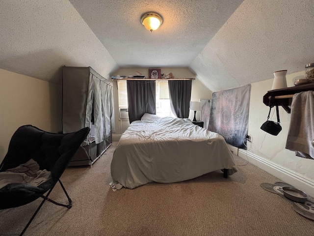 bedroom featuring a textured ceiling, light colored carpet, and vaulted ceiling