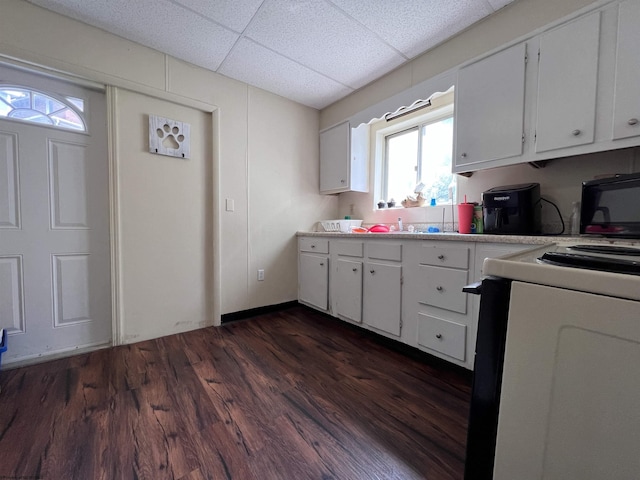 kitchen featuring white cabinets, white range with electric stovetop, a drop ceiling, and dark wood-type flooring