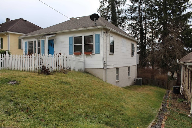 exterior space featuring a front yard and central AC