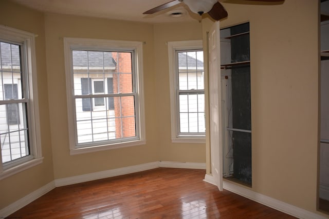 unfurnished bedroom with ceiling fan and wood-type flooring