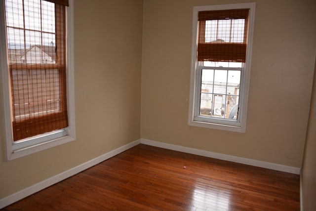 empty room with dark wood-type flooring